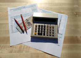 Tax filing concept with Form 1040, pencils and calculator