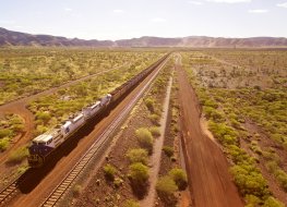 Traditional Fortescue Metals Group locomotive transporting iron ore