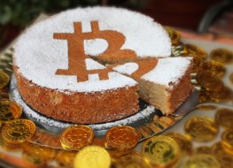 A birthday cake with the bitcoin symbol on top