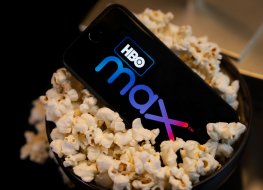 smartphone with HBO Max logo in tub of popcorn