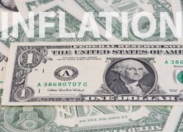 Word inflation written on top of US dollars