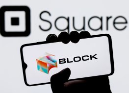 Kazan, Russia - Dec 02, 2021: Square, Inc. changes name to Block. Smartphone with Block logo on screen in hand on background of Square logo.